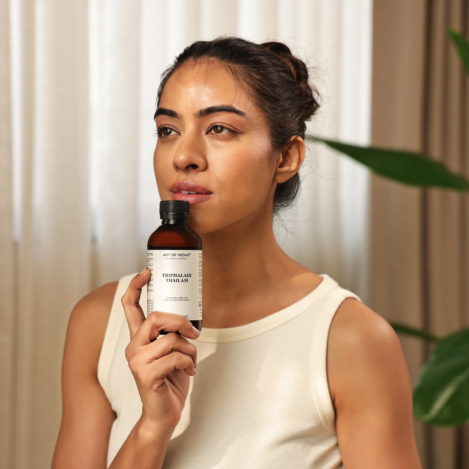 Art of Vedas Triphaladi Thailam Hair Massage Oil - Woman Holding Ayurvedic Hair Oil for Hair Growth and Scalp Health